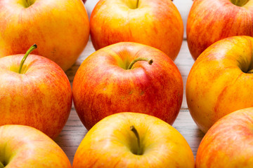 apple fruits in a row, white wooden table background