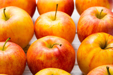 apple fruits in a row, white wooden table background