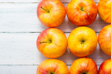 apple fruits in a row, white wooden table background