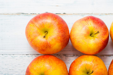 apple fruits in a row, white wooden table background