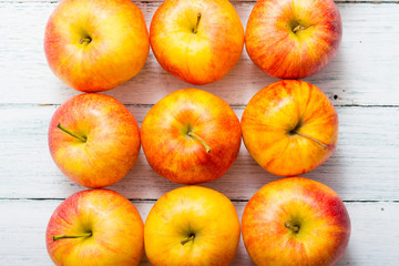 apple fruits in a row, white wooden table background