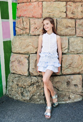 Portrait of adorable smiling little girl child schoolgirl teenager outdoors