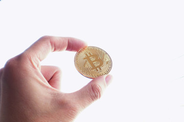 Hand hold a Gold bitcoin