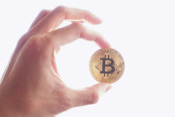 Hand hold a Gold bitcoin