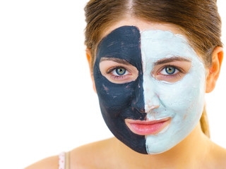 Girl with black white mud mask on face