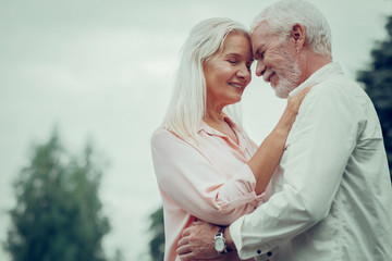 Obraz premium Pleasant nice aged couple hugging each other