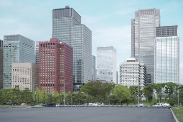 A group building with tree and road in a modern city in Tokyo. - Image