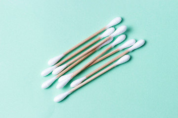 cotton swabs isolated on green background, hygiene concept