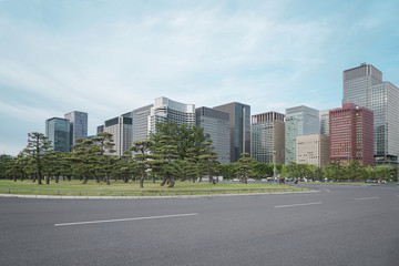 Fototapeta na wymiar A group building with tree and road in a modern city in Tokyo. - Image