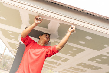 Construction worker are plastered a ceiling. Build a house concept.