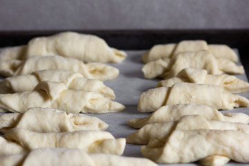 raw rolled croissants for baking laying on tray