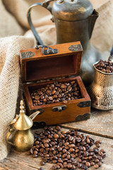 coffee beans and turk on a wooden background