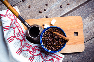 Fresh coffee in cezve on wooden table