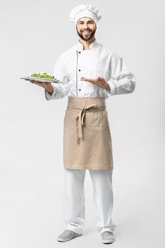 Handsome Male Chef With Salad On White Background