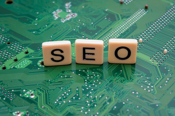 Search Engine Optimization concept with letters SEO spelled out on computer