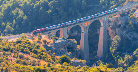 A diesel train passing over the bridge - Varda railway bridge - Adana, Turkey  - obrazy, fototapety, plakaty