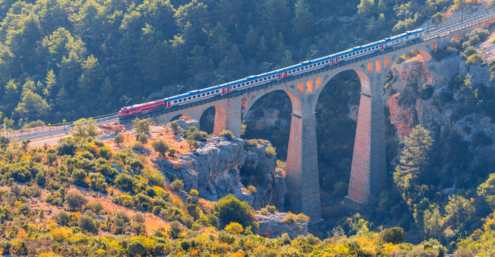A diesel train passing over the bridge - Varda railway bridge - Adana, Turkey 