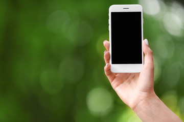 Young woman with mobile phone outdoors