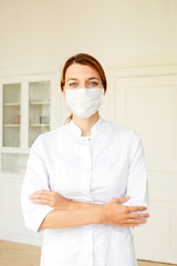 Friendly young female doctor in uniform in medical office