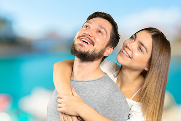 Fototapeta premium Happy couple embracing and looking at camera
