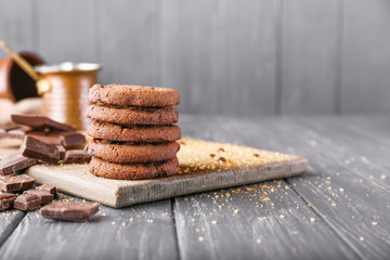 Tasty chocolate cookies on wooden table