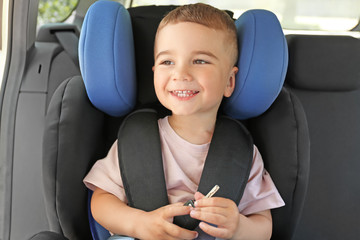 Baby boy buckled in car seat