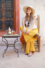 Elegant woman dirnking mint tea in Moroccan riad