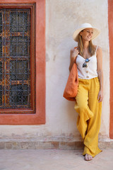 Elegant stylish woman smiling in Moroccan riad