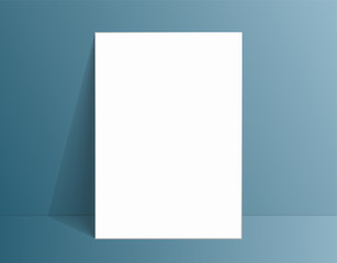 White poster mockup standing on the floor near blue wall. Blank Canvas Mockup for design