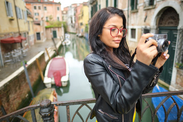 Travel photographer woman with camera in Venice, Italy.