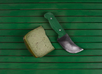 piece of green pesto cheese on a green background