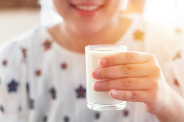 Girl teen drinking milk for healthy teeth and good smile concept