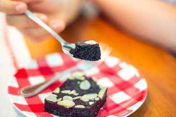 good healthy unsweetened dessert delicious almonds chocolate brownie cake slice on spoon