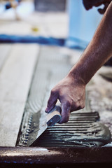 Leveling ceramic tiles on a floor. Shallow depth of field.