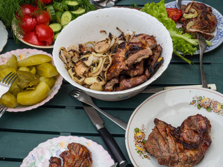 Table background and grill barbrcue time in garden, with fresh vegetables and salad
