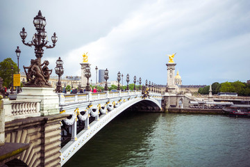 Fototapeta na wymiar Beautiful view of Pont Alexandre III, bridge with golden sculptures and street lamps, Paris, France