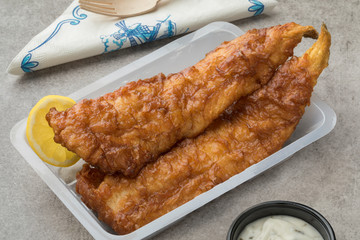  Fried fish fillet, called lekkerbek in Dutch served with sauce and lemon