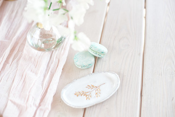 Sweet french macaroons on wood flat lay copyspace. Top voew on set of three purple macaroons on wooden board, lying diagonally on wooden table, void