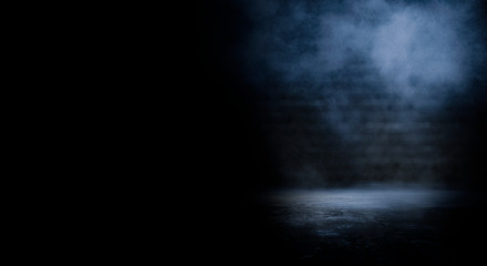 Dark empty scene, blue neon searchlight light, wet asphalt, smoke, night view, rays. Empty black studio room. Dark background. Abstract dark empty studio room texture.  Product showcase spotlight back