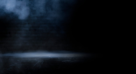 Dark empty scene, blue neon searchlight light, wet asphalt, smoke, night view, rays. Empty black studio room. Dark background. Abstract dark empty studio room texture.  Product showcase spotlight back