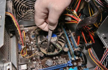 Inside details of the old personal computer. Cooler, motherboard, wires and video card in the dust....