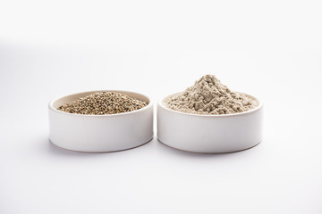 Bajra (pearl millet) / sorghum grains with it's flour or powder in a bowl, selective focus