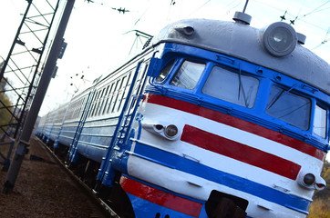 Old soviet electric train with outdated design moving by rail
