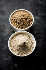 Bajra (pearl millet) / sorghum grains with it's flour or powder in a bowl, selective focus