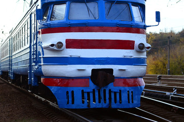 Old soviet electric train with outdated design moving by rail