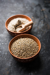Bajra (pearl millet) / sorghum grains with it's flour or powder in a bowl, selective focus