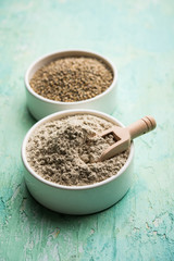 Bajra (pearl millet) / sorghum grains with it's flour or powder in a bowl, selective focus