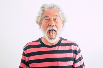 Nice and rare people old mature expression in portrait - fun with on limit age concept - mature male show his tongue with crazy hair and face - cute handsome male funny retired lifestyle