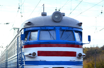 Old soviet electric train with outdated design moving by rail