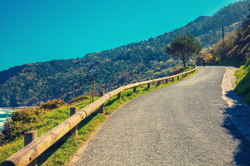 Mountain road along the sea on a sunny day